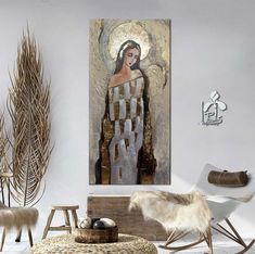 a living room filled with furniture and art on the wall above it is a painting of an angel