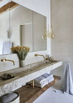 a bathroom with two sinks and mirrors on the wall