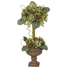 a vase filled with flowers and greenery on top of a table