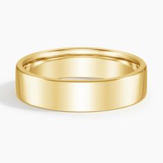 a plain wedding ring in yellow gold, with a flat surface and slight edges on the side