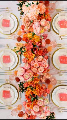 an overhead view of a table set with place settings, plates and flowers on it