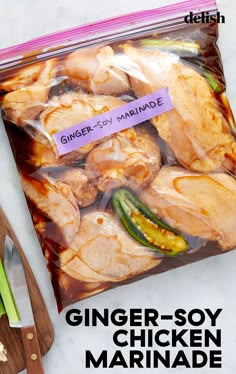 a bag of chicken marinade sitting on top of a counter next to a knife