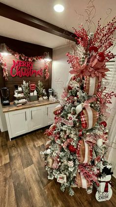 a christmas tree decorated with red and white ribbons