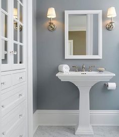 a bathroom with gray walls and white fixtures on the bottom right hand corner is an instagram post about paint colors