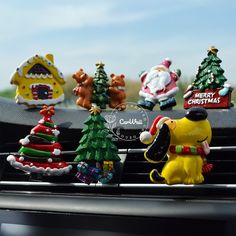 christmas decorations are sitting on the dashboard of a car