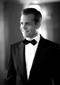 a black and white photo of a man in a tuxedo