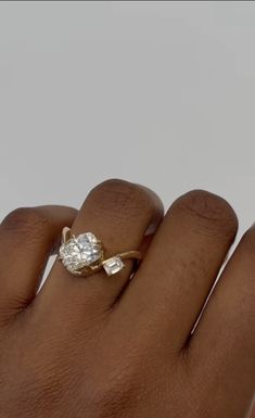 a woman's hand with a diamond ring on it