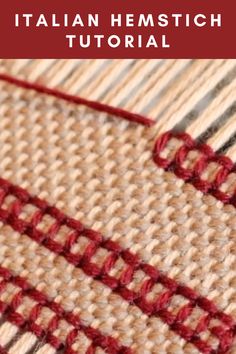 close up view of red thread on the side of a piece of woven material with white and beige stripes