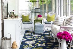 a living room filled with lots of furniture and flowers in vases on the floor