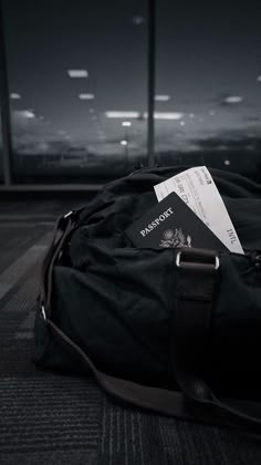 a black bag sitting on top of an airport floor