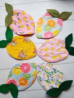 four pieces of fabric with fruit on them