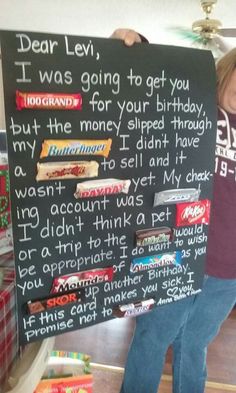 a child holding up a chalk board with writing on it