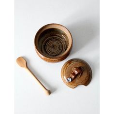 two wooden spoons sitting next to each other on top of a white countertop