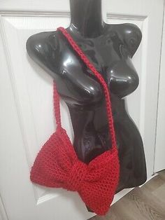 a mannequin wearing a red crocheted purse