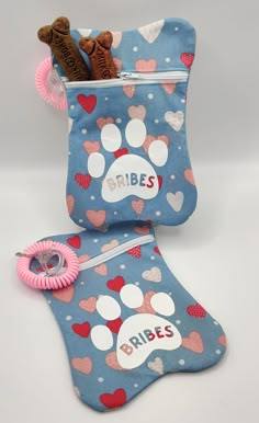 two small pouches with dog paw prints and the word brides written on them