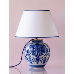 a blue and white lamp on a table