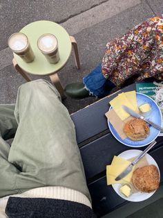 two people sitting at a table with plates of food