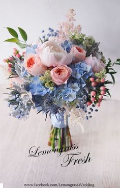 a bouquet of pink and blue flowers on a table