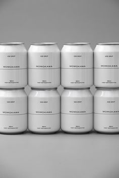 six white cans stacked on top of each other in front of a gray background,