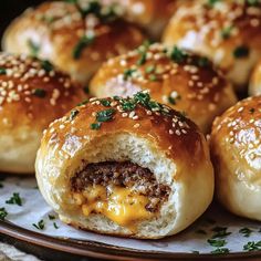 rolls with cheese and meat inside on a plate