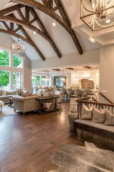 a living room filled with furniture and large windows