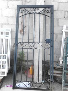 an iron gate in front of a brick wall