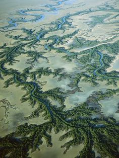 an aerial view of a river and land