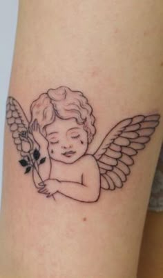 a small tattoo of an angel holding a flower