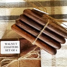 there is a wooden box with four pieces of sausage on it and a sign that says walnut coasters set of 4