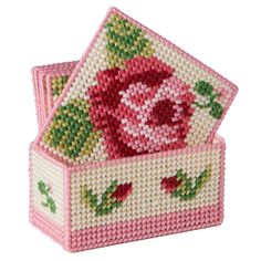 two pink boxes with roses on them are made out of plastic bead and thread