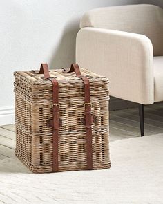 a wicker basket sitting on the floor next to a chair