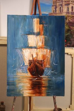 an easel with a painting of a ship on it