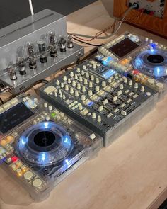 two electronic equipment sitting on top of a wooden table