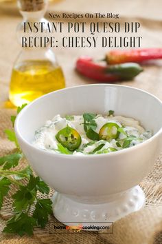 a white bowl filled with cheese and vegetables on top of a table next to other ingredients