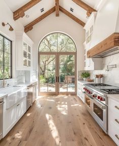 an open kitchen with white cabinets and wood flooring is pictured in this image from the inside