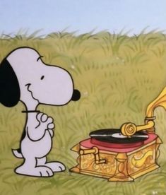 a snoopy dog is playing the record player in front of a golden record box