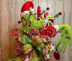 the grinch is holding candy canes in his hand