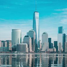 the city skyline is reflected in the water