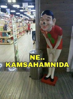 a statue of a man standing next to a trash can with the words ne, kamshaminda on it