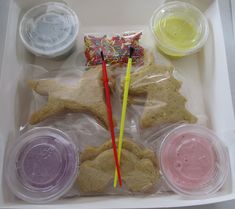 a box filled with different types of food and drinks on top of a table next to plastic containers