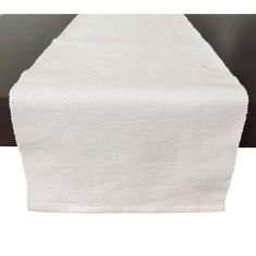 a white table runner on top of a black table