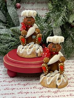 two gingerbread men are sitting on top of a cake