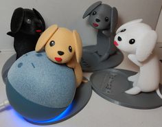 three stuffed animals sitting on top of an electronic device