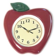 an apple shaped clock with a green leaf on the top and numbers in red, white and black