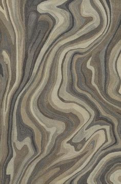 an area rug with wavy design in grey, beige and brown colors on the floor