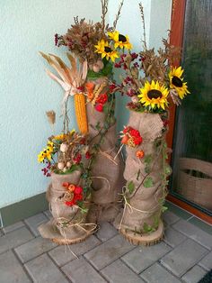 two burlocks with sunflowers and corn on the cob in them