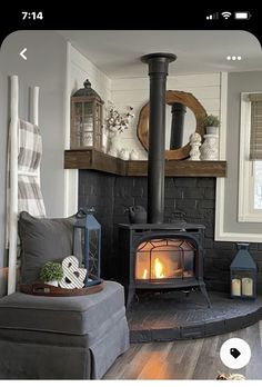 a living room filled with furniture and a fire place in the middle of it's fireplace