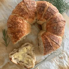 a loaf of bread with butter and rosemary on top