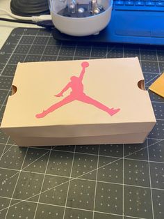 a cardboard box sitting on top of a cutting board next to a bowl and scissors