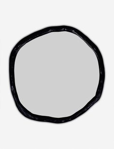 an oval shaped mirror with black paint on it's edges, against a white background